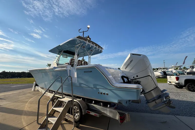 Slide: The Image of 2026 Bertram 34CC boat with Mercury engine on trailer under clear blue sky. - 6
