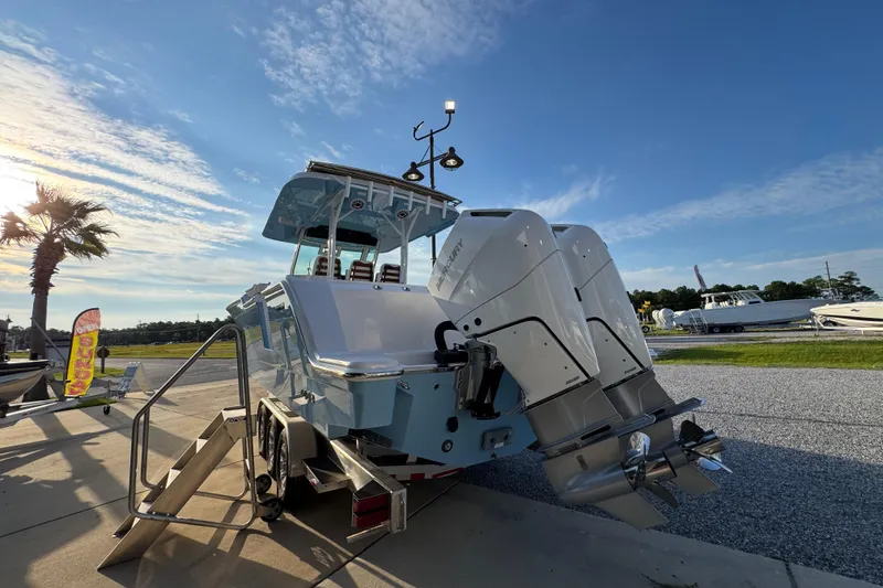 Slide: The Image of 2026 Bertram 34CC boat with dual outboard engines on display under a clear blue sky. - 7