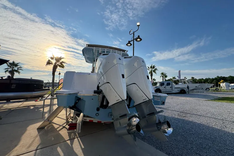Slide: The Image of 2026 Bertram 34CC boat with dual engines, parked under a sunny sky with palm trees. - 8