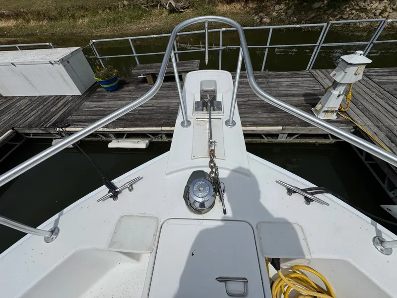 Slide: The Image of Bow view of a 2001 Mainship 390 yacht docked at a marina. - 11
