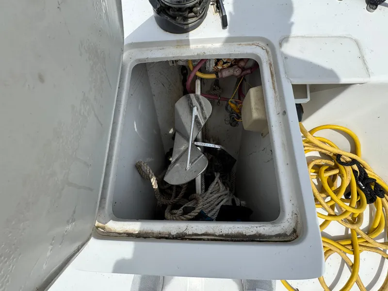 Slide: The Image of Anchor storage compartment on 2001 Mainship 390 boat with ropes and cables. - 13
