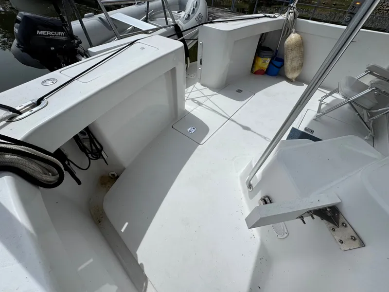 Slide: The Image of 2001 Mainship 390 boat deck with Mercury engine, ropes, and seating area. - 20
