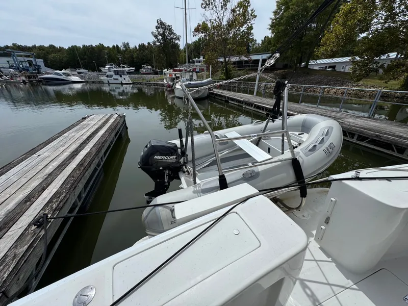 Slide: The Image of 2001 Mainship 390 docked with inflatable boat and Mercury outboard motor. - 22