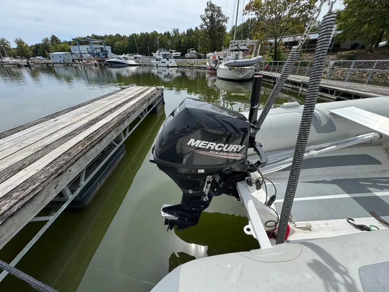 Slide: The Image of Mercury outboard motor on a Mainship 390, 2001 model, docked at a marina. - 25