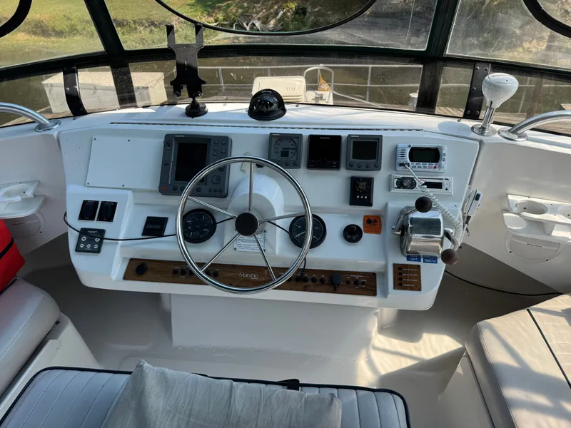 Slide: The Image of Helm of 2001 Mainship 390 boat with steering wheel and navigation instruments. - 30