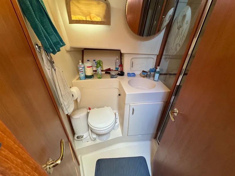 Slide: The Image of Bathroom interior of 2001 Mainship 390 yacht, featuring sink, toilet, and storage. - 37