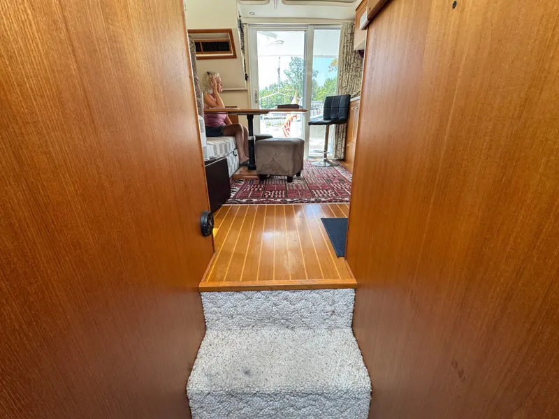 Slide: The Image of Interior view of 2001 Mainship 390 yacht with wooden flooring and seating area. - 38