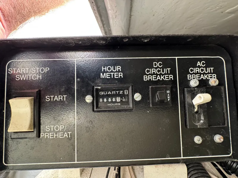 Slide: The Image of Control panel of a 2001 Mainship 390 with hour meter and circuit breakers. - 46