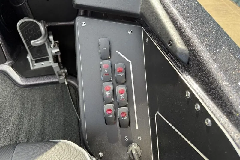 Slide: The Image of Control panel of 2023 Ranger RT198P boat with switches and foot pedal. - 17