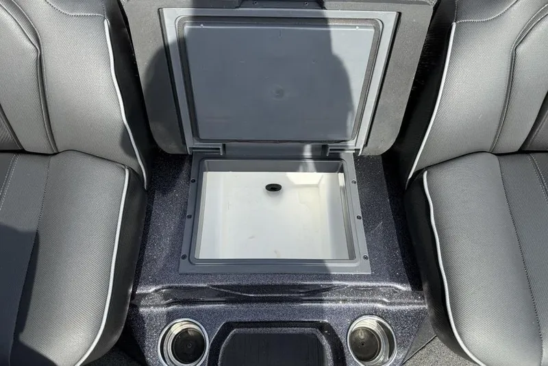 Slide: The Image of 2023 Ranger RT198P boat interior with open storage compartment between seats. - 19