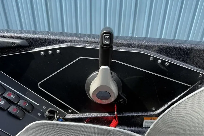Slide: The Image of 2023 Ranger RT198P boat throttle control with "UP" and "DN" buttons, close-up view. - 20