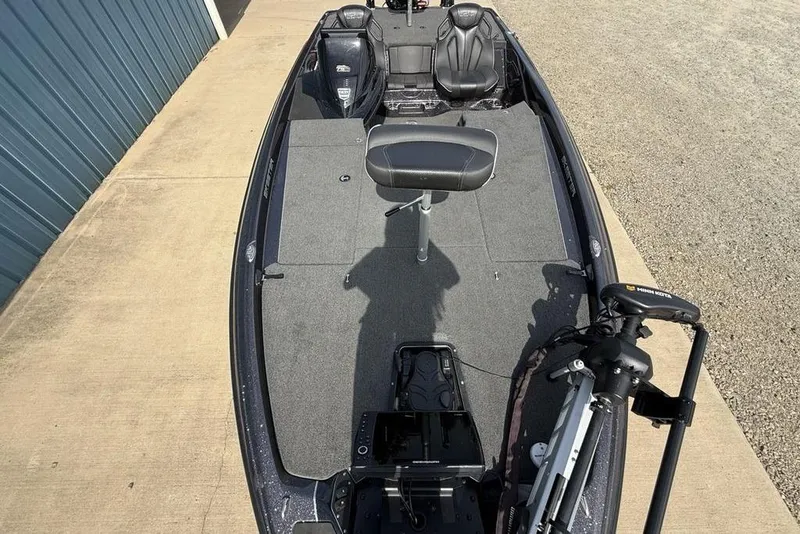 Slide: The Image of 2023 Ranger RT198P fishing boat with seating and trolling motor, docked on concrete. - 24