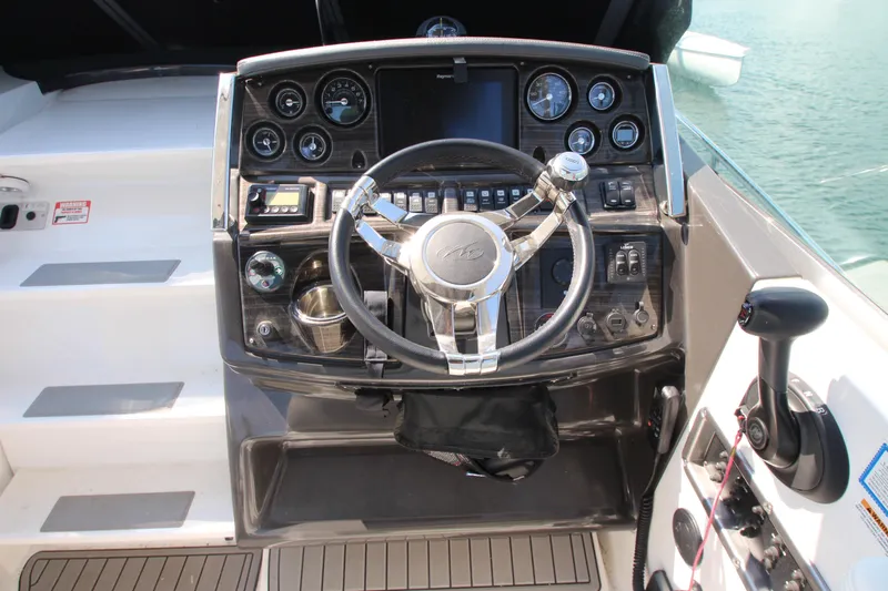 Slide: The Image of Cockpit of 2018 Monterey 295 Sport Yacht with steering wheel and control panel. - 15