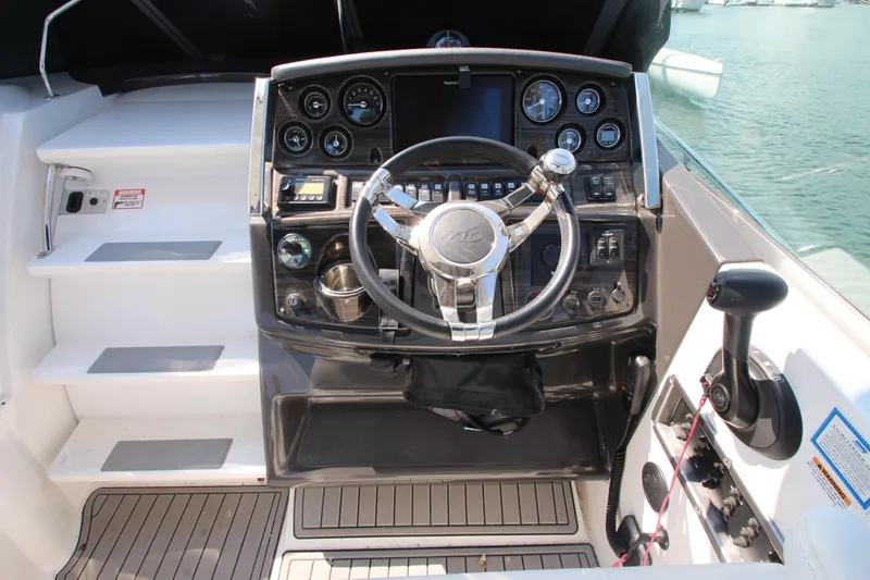 Slide: The Image of Cockpit of 2018 Monterey 295 Sport Yacht with steering wheel and control panel. - 16