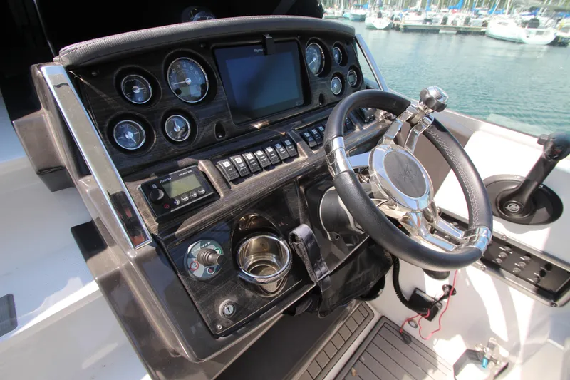 Slide: The Image of Cockpit of 2018 Monterey 295 Sport Yacht with steering wheel and control panel. - 17