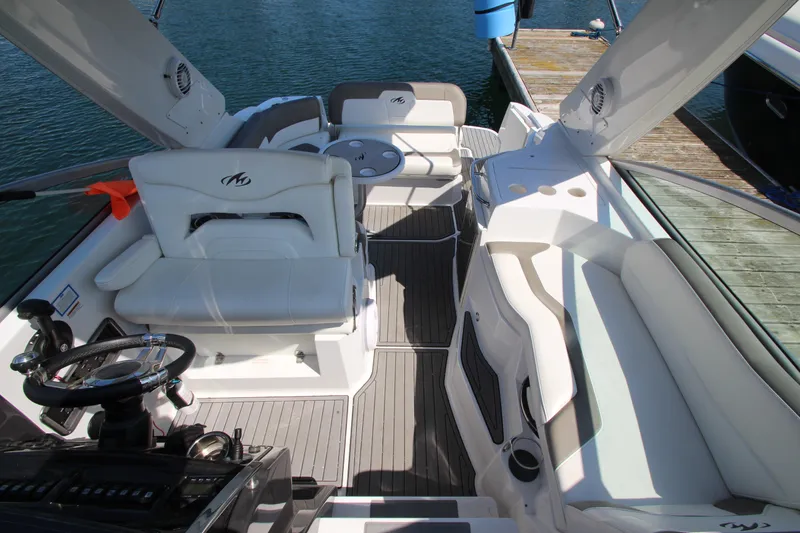 Slide: The Image of 2018 Monterey 295 Sport Yacht interior with white seating and sleek design. - 20