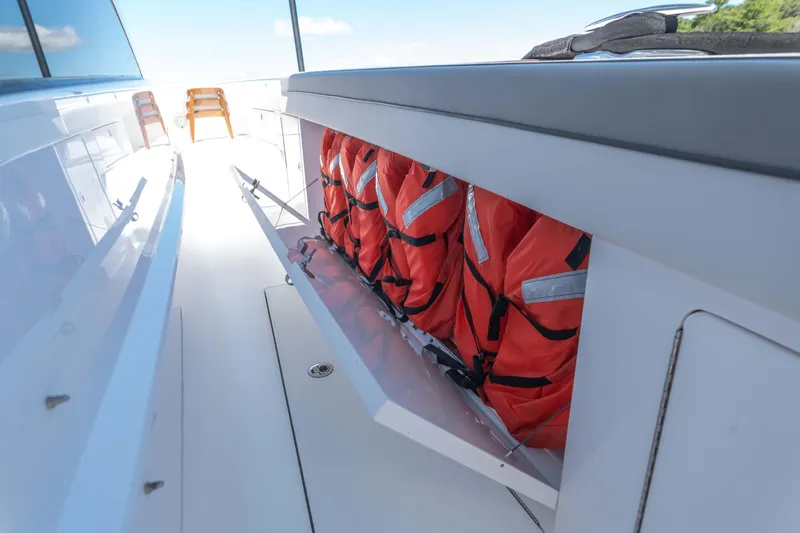 Slide: The Image of 2025 Valhalla Boatworks V-46 with life jackets stored in a side compartment. - 25