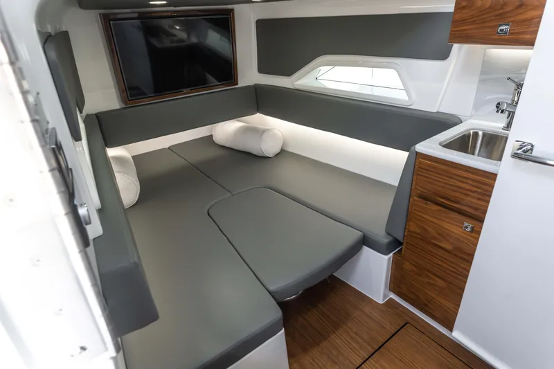 Slide: The Image of 2025 Valhalla Boatworks V-46 interior with modern seating, TV, and kitchenette. - 30