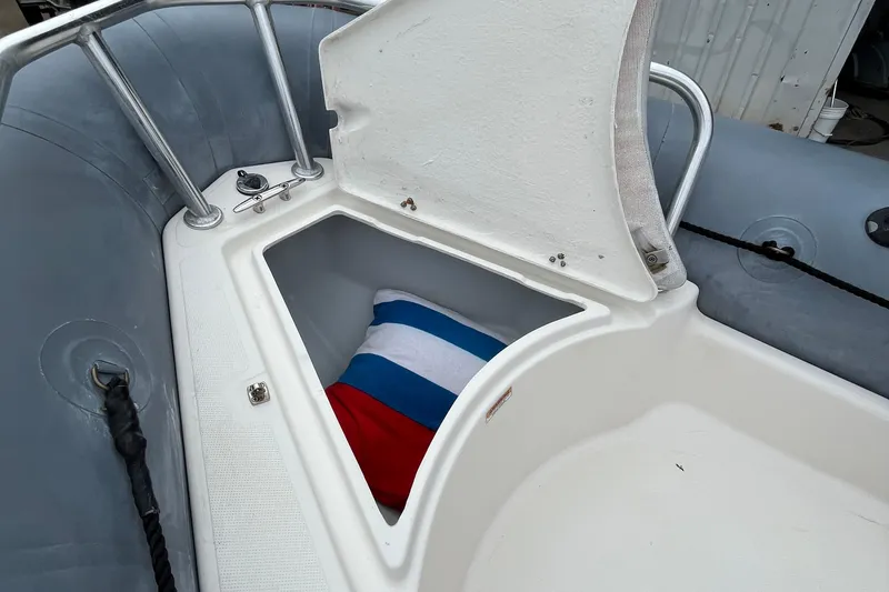 Slide: The Image of 2019 Zodiac Open 4.8 boat storage compartment with colorful cushion inside. - 7