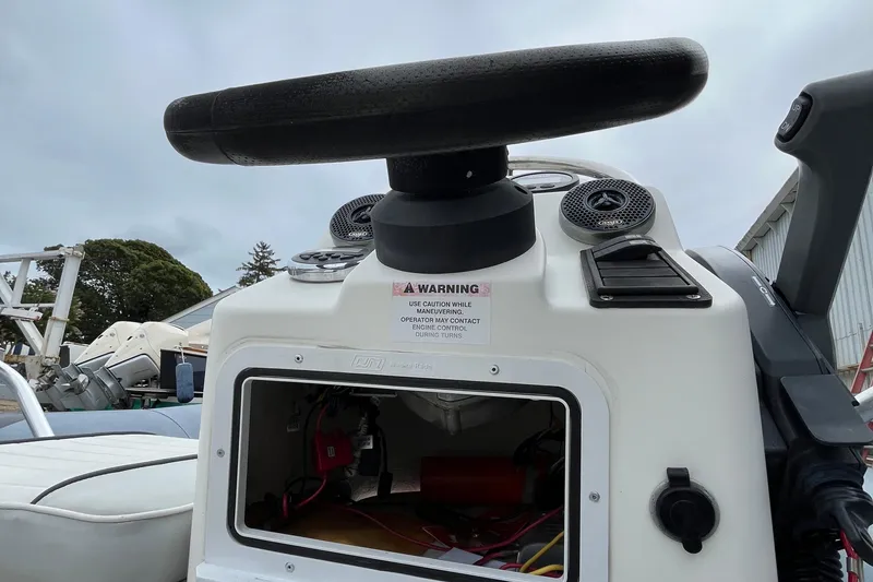 Slide: The Image of 2019 Zodiac Open 4.8 boat console with steering wheel and warning label. - 8