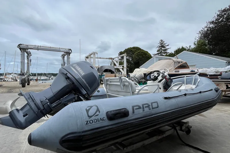 Slide: The Image of 2019 Zodiac Open 4.8 inflatable boat with Yamaha engine in a marina setting. - 3