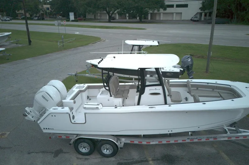 The Image of 2026 Sea Hunt Gamefish 28 Forward Seating boat on trailer, parked outdoors. - 0