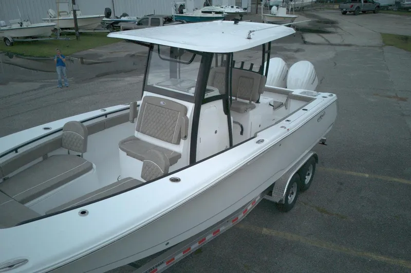 Slide: The Image of 2026 Sea Hunt Gamefish 28 Forward Seating boat on trailer, featuring spacious seating and modern design. - 10