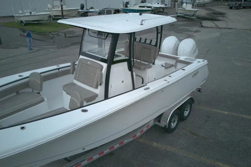Slide: The Image of 2026 Sea Hunt Gamefish 28 Forward Seating boat on trailer, featuring dual engines. - 11
