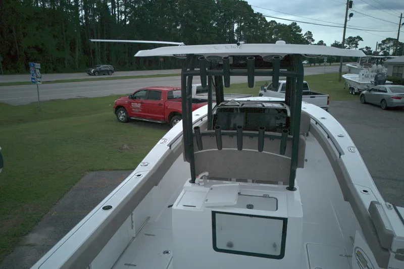 Slide: The Image of 2026 Sea Hunt Gamefish 28 Forward Seating boat, parked near a road with vehicles. - 13