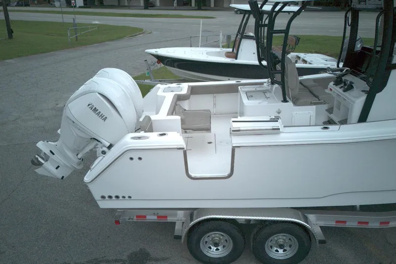 Slide: The Image of 2026 Sea Hunt Gamefish 28 boat with Yamaha engine on trailer, side view. - 17