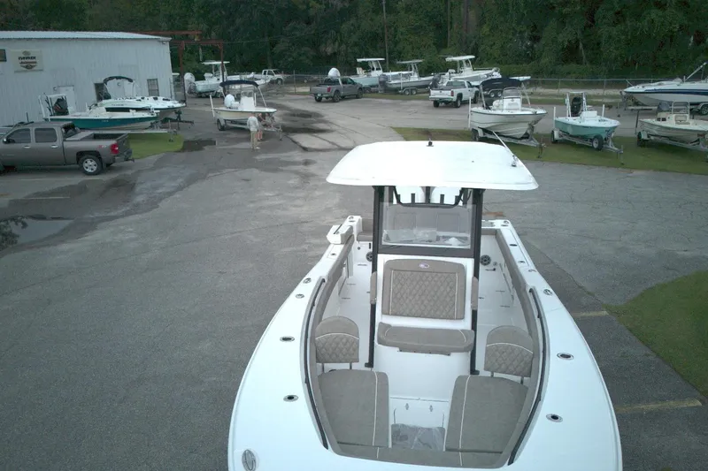 Slide: The Image of 2026 Sea Hunt Gamefish 28 Forward Seating boat in a dealership lot with multiple boats. - 21