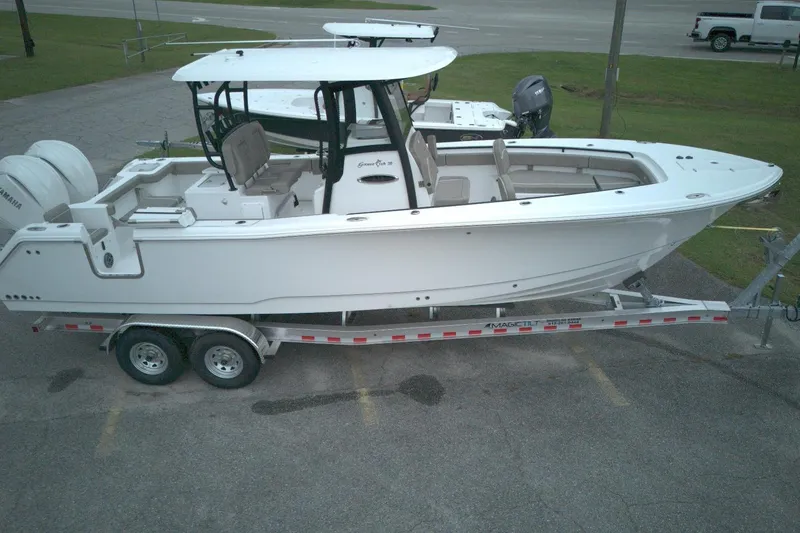 Slide: The Image of 2026 Sea Hunt Gamefish 28 Forward Seating boat on trailer, side view. - 3