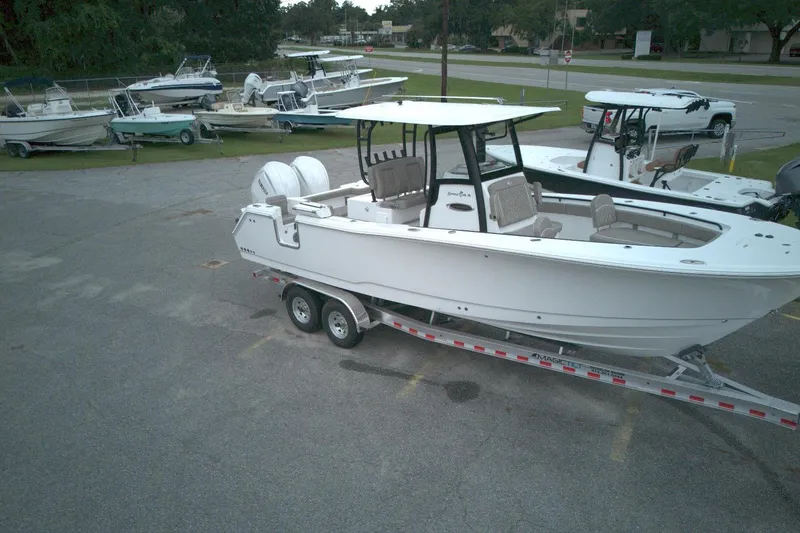 Slide: The Image of 2026 Sea Hunt Gamefish 28 Forward Seating boat on trailer in parking lot. - 4