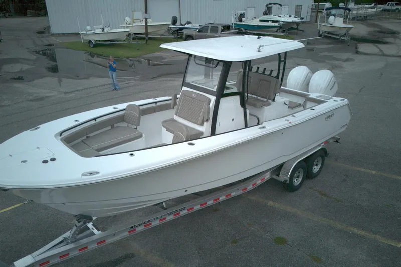 Slide: The Image of 2026 Sea Hunt Gamefish 28 Forward Seating boat on trailer in parking lot. - 9