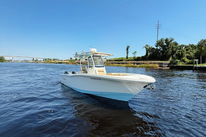 Slide: The Image of 2019 Pioneer 266 Pelagic boat on water near a bridge, with Yamaha engines. - 1