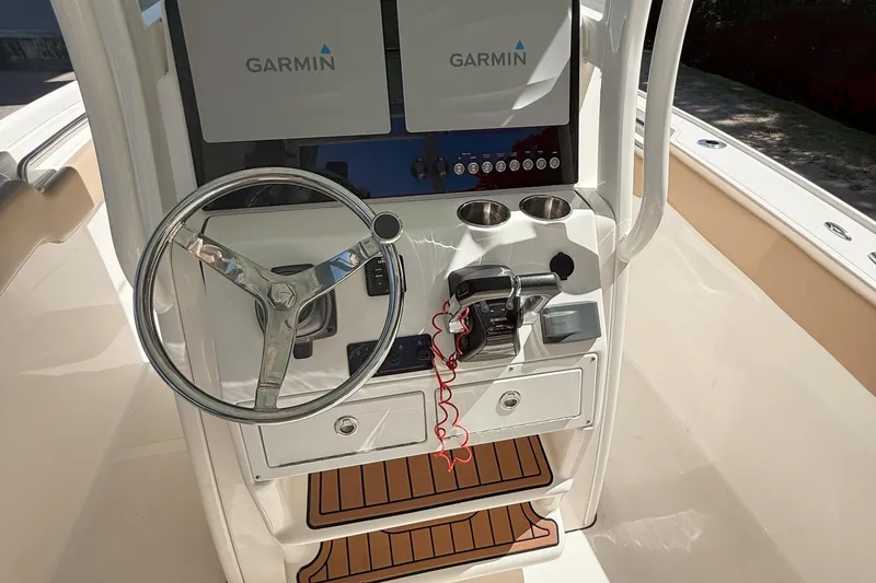 Slide: The Image of 2019 Pioneer 266 Pelagic boat console with Garmin displays and steering wheel. - 13