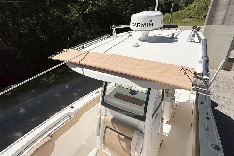 Slide: The Image of 2019 Pioneer 266 Pelagic boat with Garmin radar, beige canopy, and sleek design. - 14