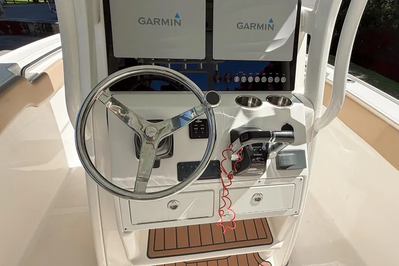 Slide: The Image of 2019 Pioneer 266 Pelagic boat helm with Garmin displays and steering wheel. - 16