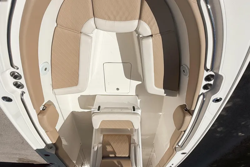 Slide: The Image of 2019 Pioneer 266 Pelagic boat interior with beige cushioned seating and sleek design. - 17