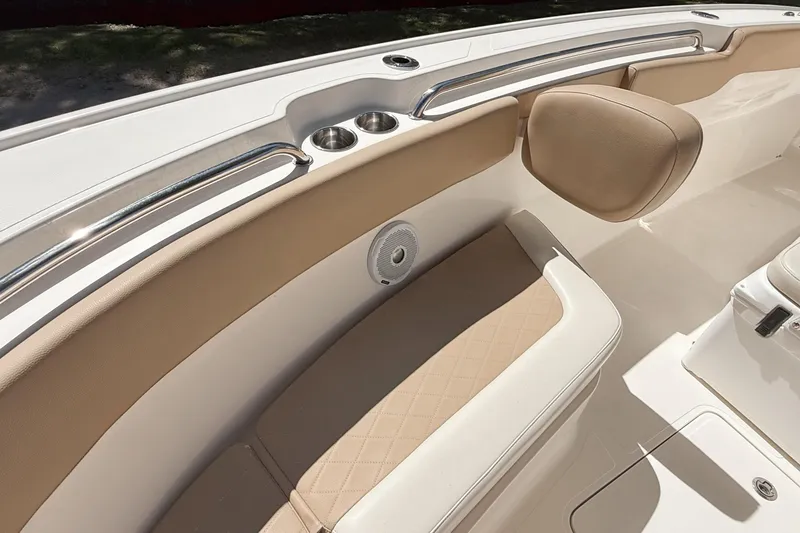 Slide: The Image of 2019 Pioneer 266 Pelagic boat interior with beige seating and cup holders. - 21