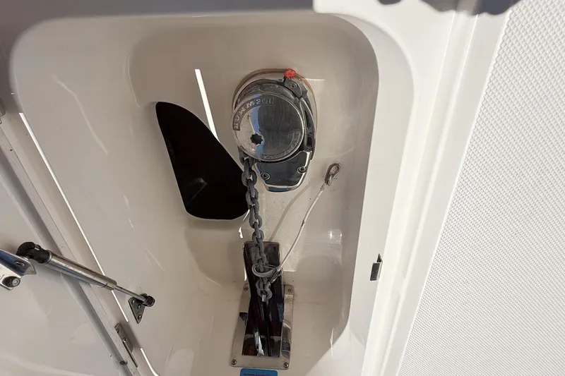 Slide: The Image of Anchor chain compartment on 2019 Pioneer 266 Pelagic boat, featuring a secure chain mechanism. - 22