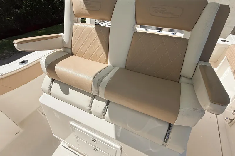 Slide: The Image of 2019 Pioneer 266 Pelagic boat seating with beige and white upholstery. - 23