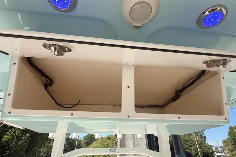 Slide: The Image of Open storage compartments on a 2019 Pioneer 266 Pelagic boat with blue LED lights. - 29