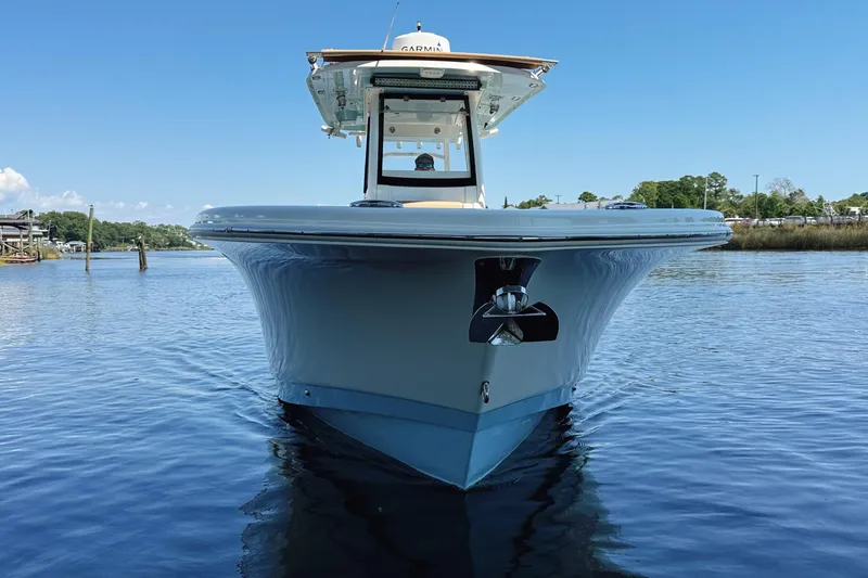 Slide: The Image of 2019 Pioneer 266 Pelagic boat on calm water, front view under clear blue sky. - 3