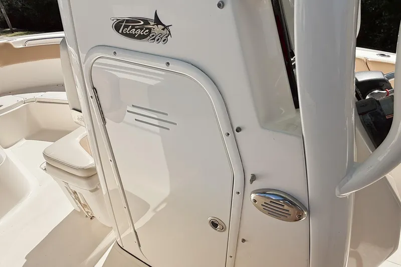 Slide: The Image of 2019 Pioneer 266 Pelagic boat interior, featuring sleek white design and seating area. - 38