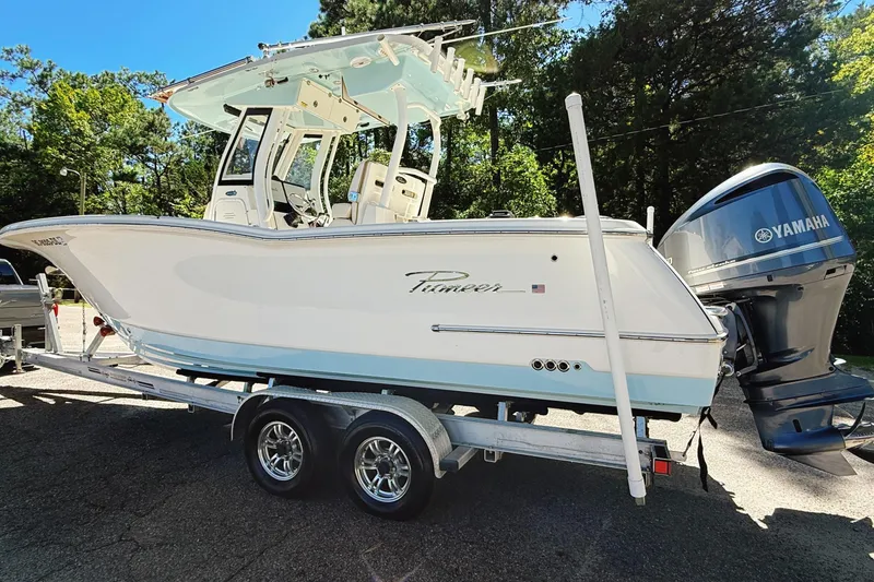 Slide: The Image of 2019 Pioneer 266 Pelagic boat on trailer with Yamaha engine, parked outdoors. - 4