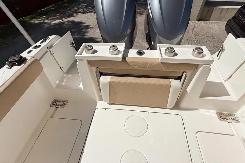 Slide: The Image of 2019 Pioneer 266 Pelagic boat interior with dual engines and beige seating. - 42