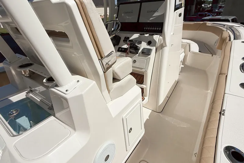 Slide: The Image of 2019 Pioneer 266 Pelagic boat interior with Garmin displays and seating. - 43
