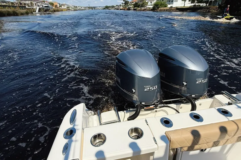 Slide: The Image of 2019 Pioneer 266 Pelagic boat with dual Yamaha 250 engines cruising on a scenic waterway. - 45
