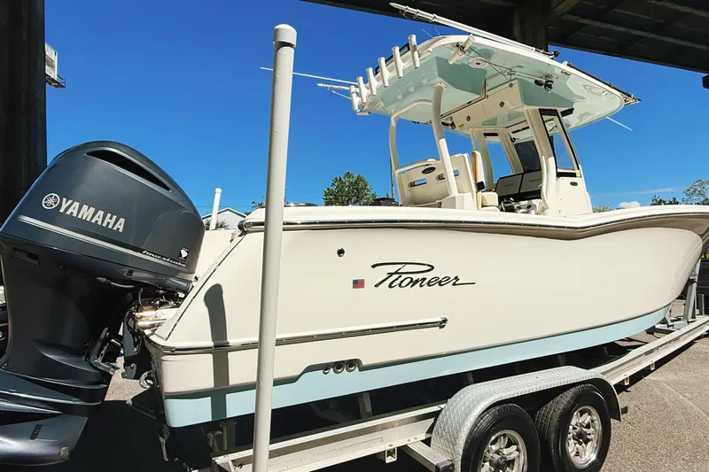 Slide: The Image of 2019 Pioneer 266 Pelagic boat on trailer with Yamaha engine, under clear blue sky. - 6